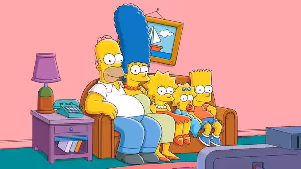 Homer Simpson and Marge Simpson with children seated on the living room couch