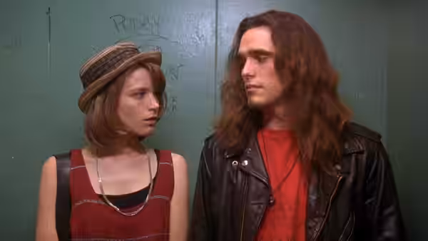 Janet Livermore (Bridget Fonda) and Cliff Poncier (Matt Dillon) standing indoors