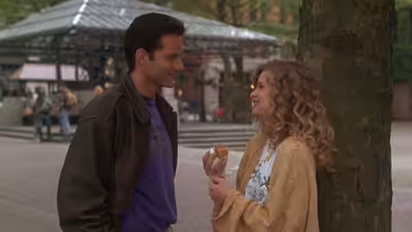 Steve Dunne (Campbell Scott) talking with Linda Powell (Kyra Sedgwick) outdoors