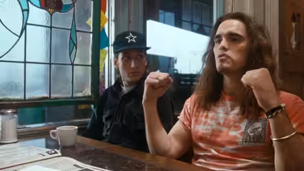 Cliff Poncier (Matt Dillon) at a diner table with another man