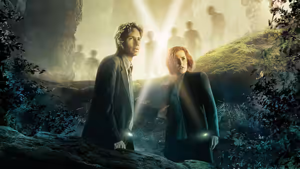 Fox Mulder (David Duchovny) and Dana Scully (Gillian Anderson) holding flashlights in misty woods