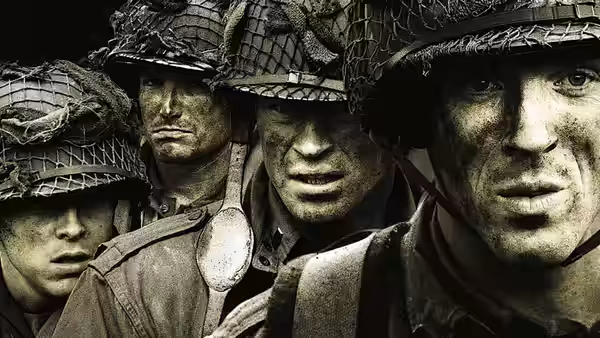 Close up of several dirty faced soldiers wearing helmets