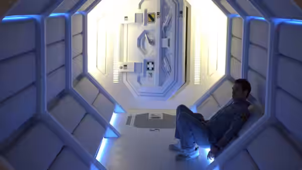 Sam Bell (Sam Rockwell) sitting inside a small white illuminated pod