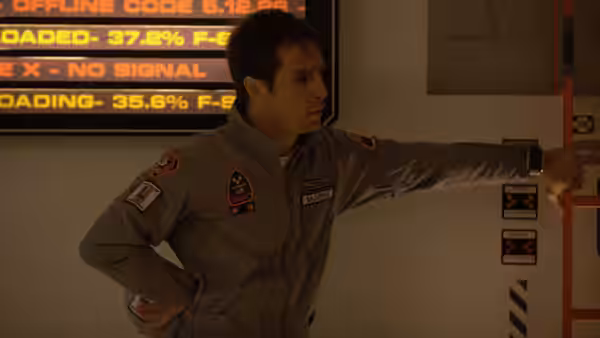 Sam Bell (Sam Rockwell) pointing at a screen in a control room