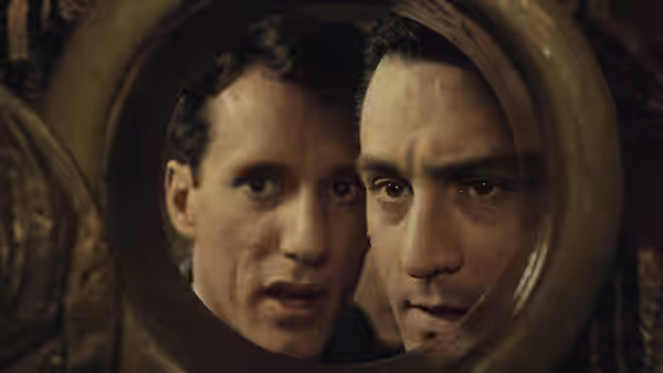 Robert De Niro and James Woods peering through a circular opening