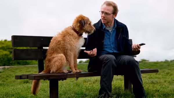 Neil (Simon Pegg) talking to his dog on a park bench