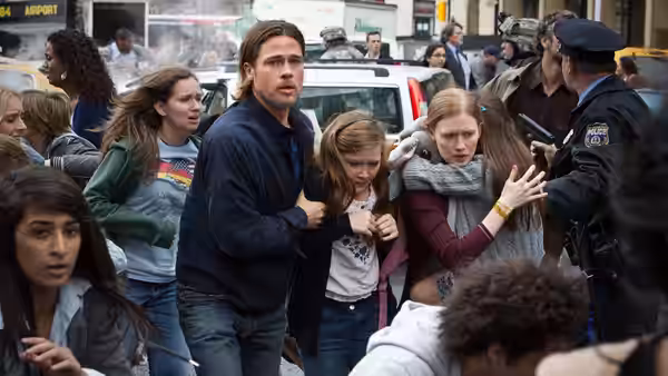 Gerry Lane (Brad Pitt) shepherds his family through a crowded street toward a vehicle