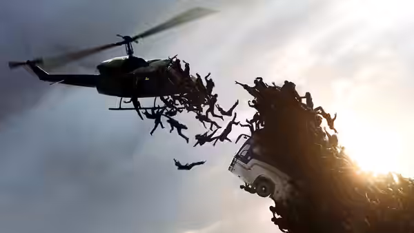 A helicopter flies beside a mass of people tumbling from a towering wall