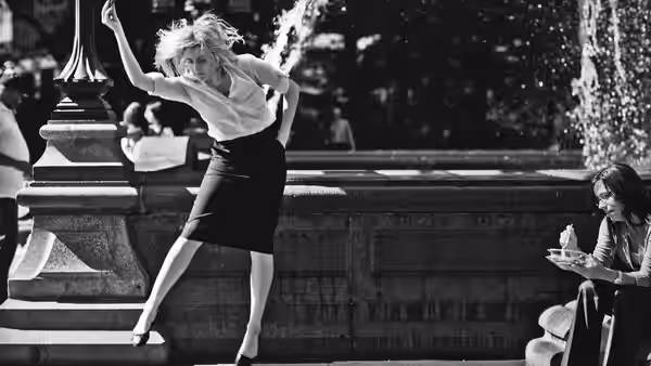 Frances (Greta Gerwig) dancing with arm raised beside a stone fountain