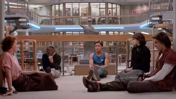 Claire Standish, Brian Johnson, Andrew Clark, Allison Reynolds and John Bender sit on the library floor