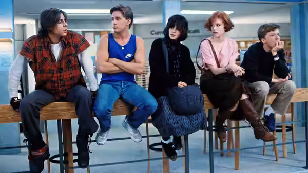 John Bender, Andrew Clark, Allison Reynolds, Claire Standish and Brian Johnson sit on a library railing