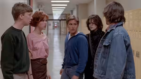 Brian Johnson, Claire Standish, Andrew Clark, Allison Reynolds and John Bender stand in a school hallway