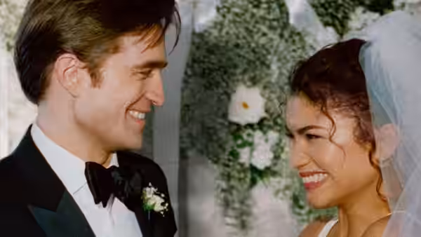 Charlie (Robert Pattinson) and Emma (Zendaya) smiling face to face at their wedding
