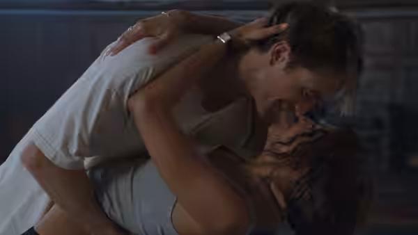 Emma (Zendaya) and Charlie (Robert Pattinson) locked in a passionate embrace indoors
