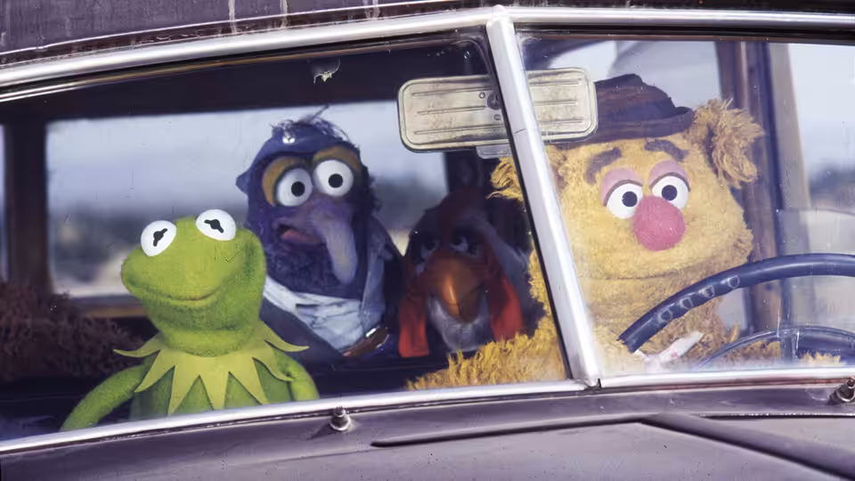 Kermit, Dr. Teeth, Gonzo, and Fozzie ride together in a car
