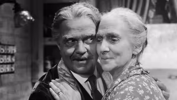 George Cooper (Thomas Mitchell) embraces his mother, Lucy Cooper (Beulah Bondi), indoors