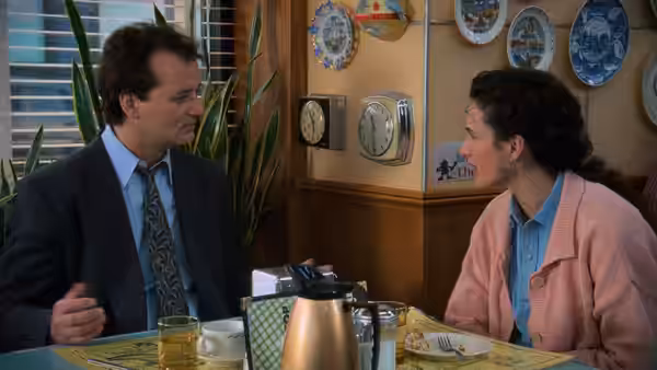 Phil Connors and Rita Hanson talking across a table in a diner