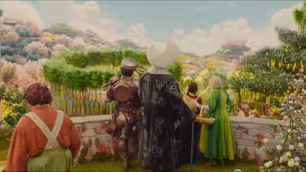 a group of costumed characters looking over a wall at a hillside