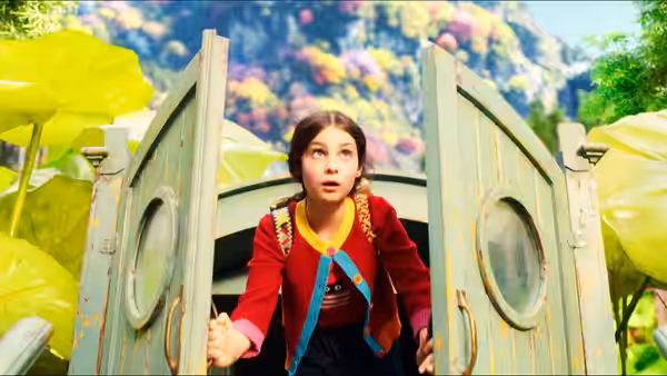 a girl in a red jacket peering through open wooden doors