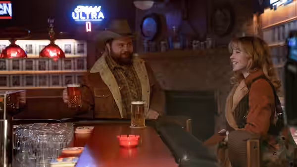 Mandy Starr (Halsey) talks with a bearded man across a bar