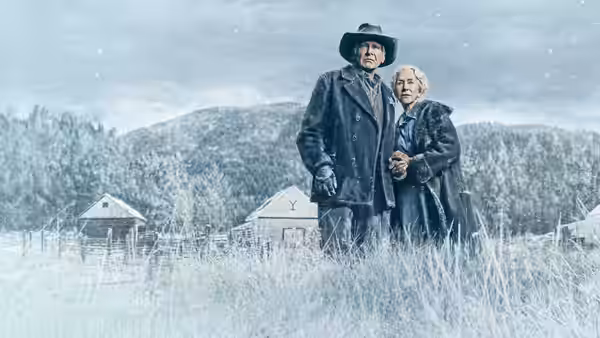 Jacob Dutton (Harrison Ford) and Cara Dutton (Helen Mirren) stand together at their snowy ranch