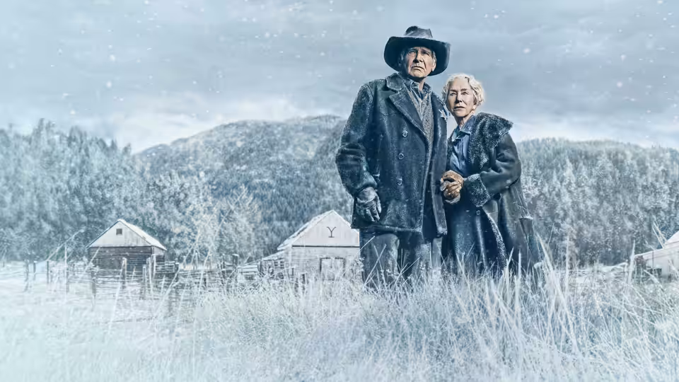 Jacob Dutton (Harrison Ford) and Cara Dutton (Helen Mirren) stand together at their snowy ranch