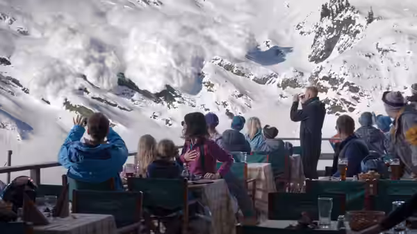 Guests watch a massive avalanche from a terrace while a man uses binoculars