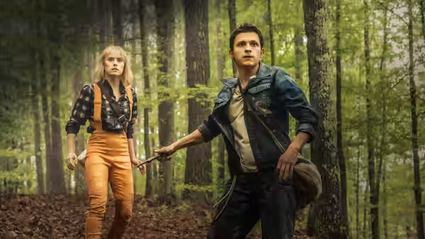 Todd Hewitt (Tom Holland) and Viola Eade (Daisy Ridley) pause among trees in the forest