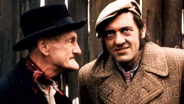 Albert (Wilfrid Brambell) faces Harold (Harry H. Corbett) against a wooden fence