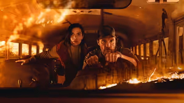 Kevin McKay (Matthew McConaughey) steers a school bus as Mary Ludwig (America Ferrera) sits beside him