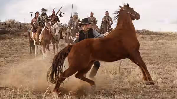 George Briggs (Tommy Lee Jones) reaches for a riderless horse as a mounted group follows