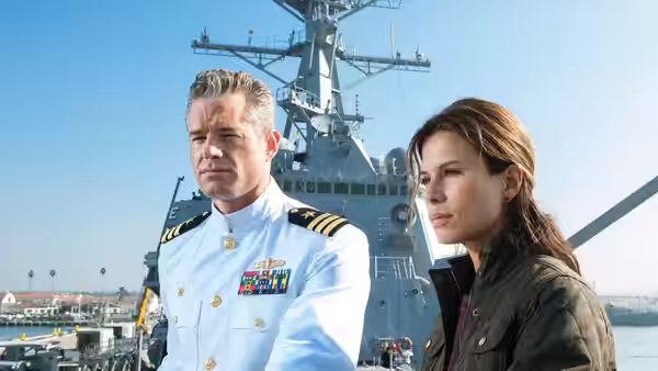 Tom Chandler (Eric Dane) and Dr. Rachel Scott (Rhona Mitra) stand before a naval ship