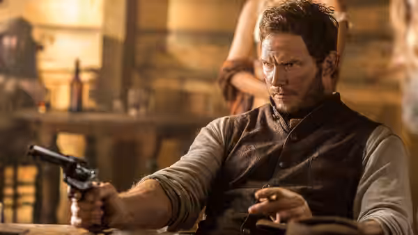 Joshua Farraday (Chris Pratt) aims a revolver inside a warmly lit room