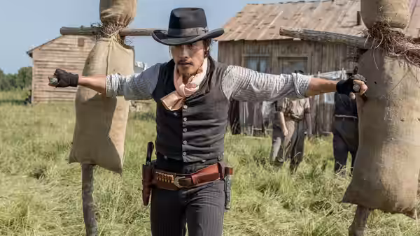 Goodnight Robicheaux (Ethan Hawke) stretches his arms between two targets at a training ground