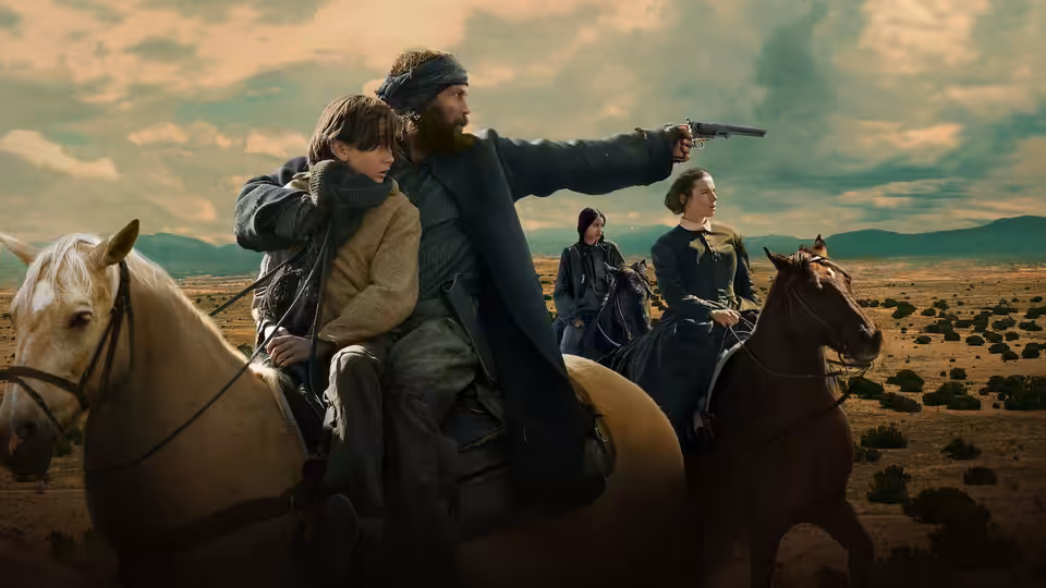 A bearded rider points a pistol across the plains, with a child beside him on horseback