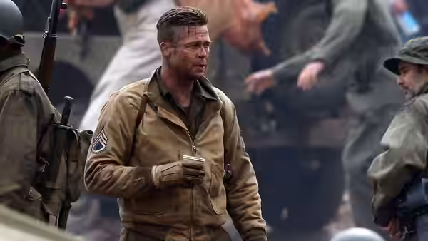 Don Collier (Brad Pitt) holds a mug among fellow soldiers