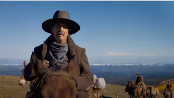 Hayes Ellison (Kevin Costner) rides across open country with a group of riders behind him