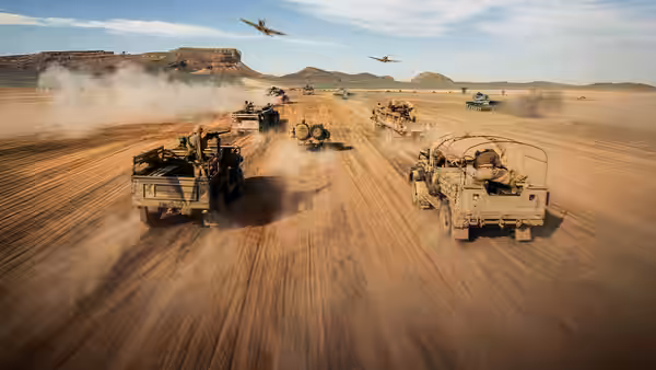 A convoy of military trucks crosses a desert airstrip beneath low-flying aircraft