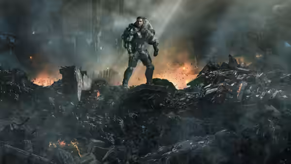 Master Chief (Pablo Schreiber) stands on a mound of rubble amid a burning battlefield