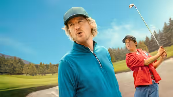 Pryce Cahill (Owen Wilson) watches as another golfer swings on the course