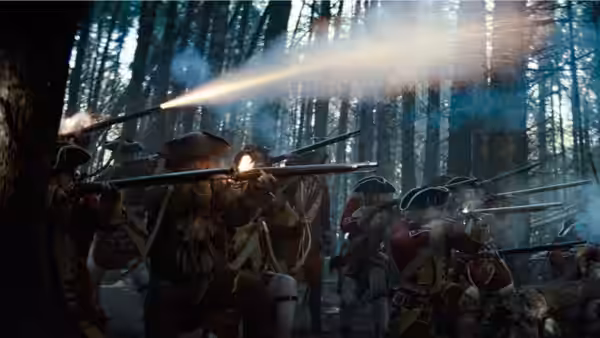 Colonial soldiers fire muskets among the trees