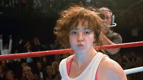 Christy Martin (Sydney Sweeney) stands in the ring while a man tends to her hair