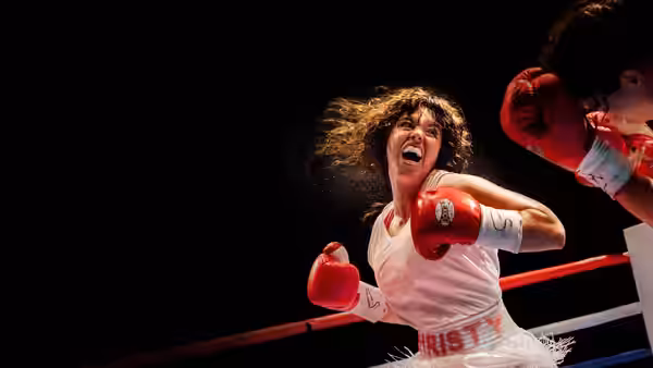 Christy Martin (Sydney Sweeney) throws a punch across the ropes in a boxing ring