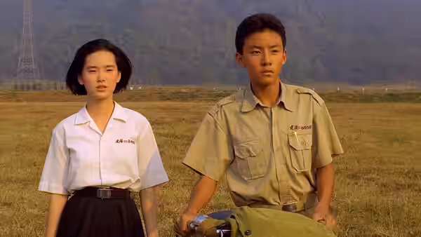 Ming (Lisa Yang) and Xiao Si'r (Chang Chen) stand together in a grassy field
