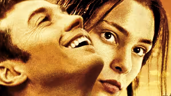 A smiling young man leans close beside a woman looking toward the viewer