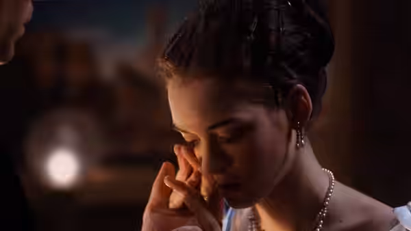 May Welland (Winona Ryder) gazing downward with hand near her face