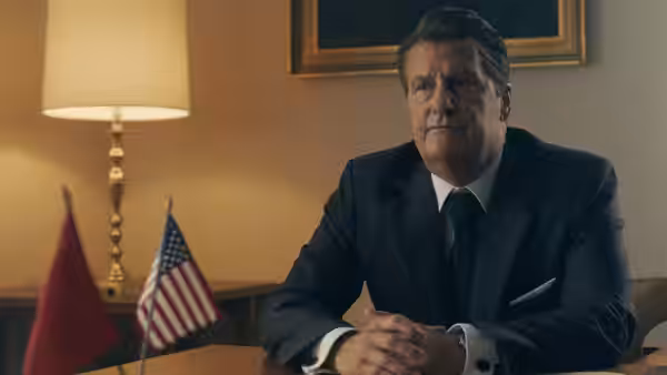 Ronald Reagan (Jeff Daniels) sits at a desk beside American and Soviet flags