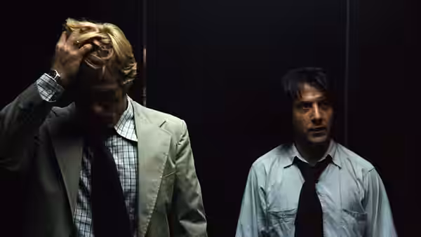 Bob Woodward and Carl Bernstein ride in a dark elevator