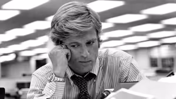 Bob Woodward rests his head on his hand at his desk