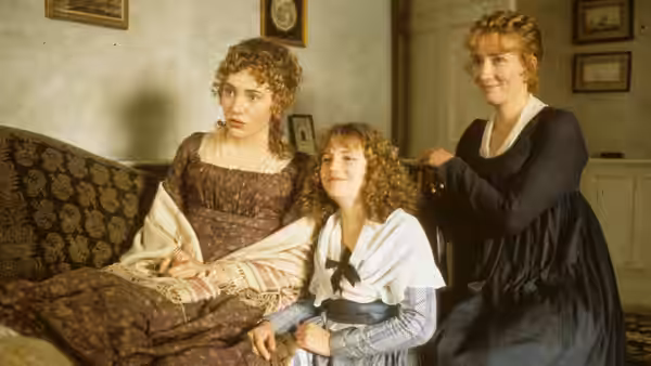 Marianne Dashwood (Kate Winslet) reclining on a sofa beside Elinor Dashwood (Emma Thompson)